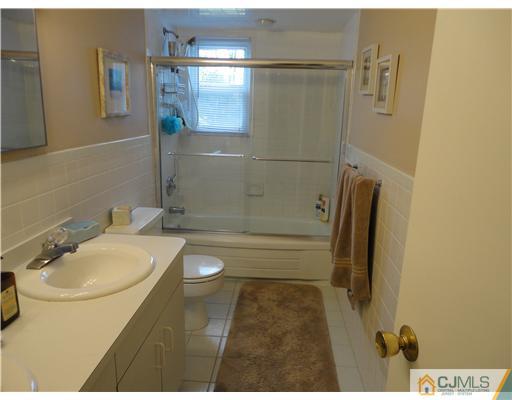 22 Innes Road East Brunswick, NJ 08816 - Photo 14 of 18 a bathroom with a sink a toilet and shower