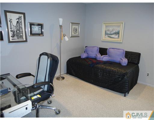 22 Innes Road East Brunswick, NJ 08816 - Photo 16 of 18 a living room with furniture and a chair