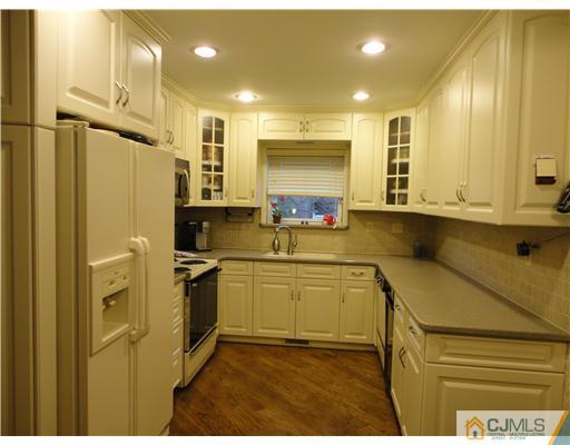 22 Innes Road East Brunswick, NJ 08816 - Photo 4 of 18 a kitchen with stainless steel appliances granite countertop a sink a stove and a refrigerator