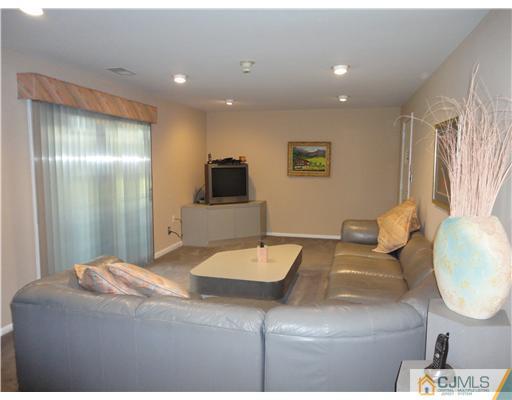 22 Innes Road East Brunswick, NJ 08816 - Photo 6 of 18 a living room with furniture and a mirror