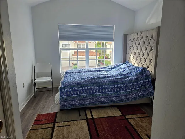 a bed sitting in a bedroom next to a window