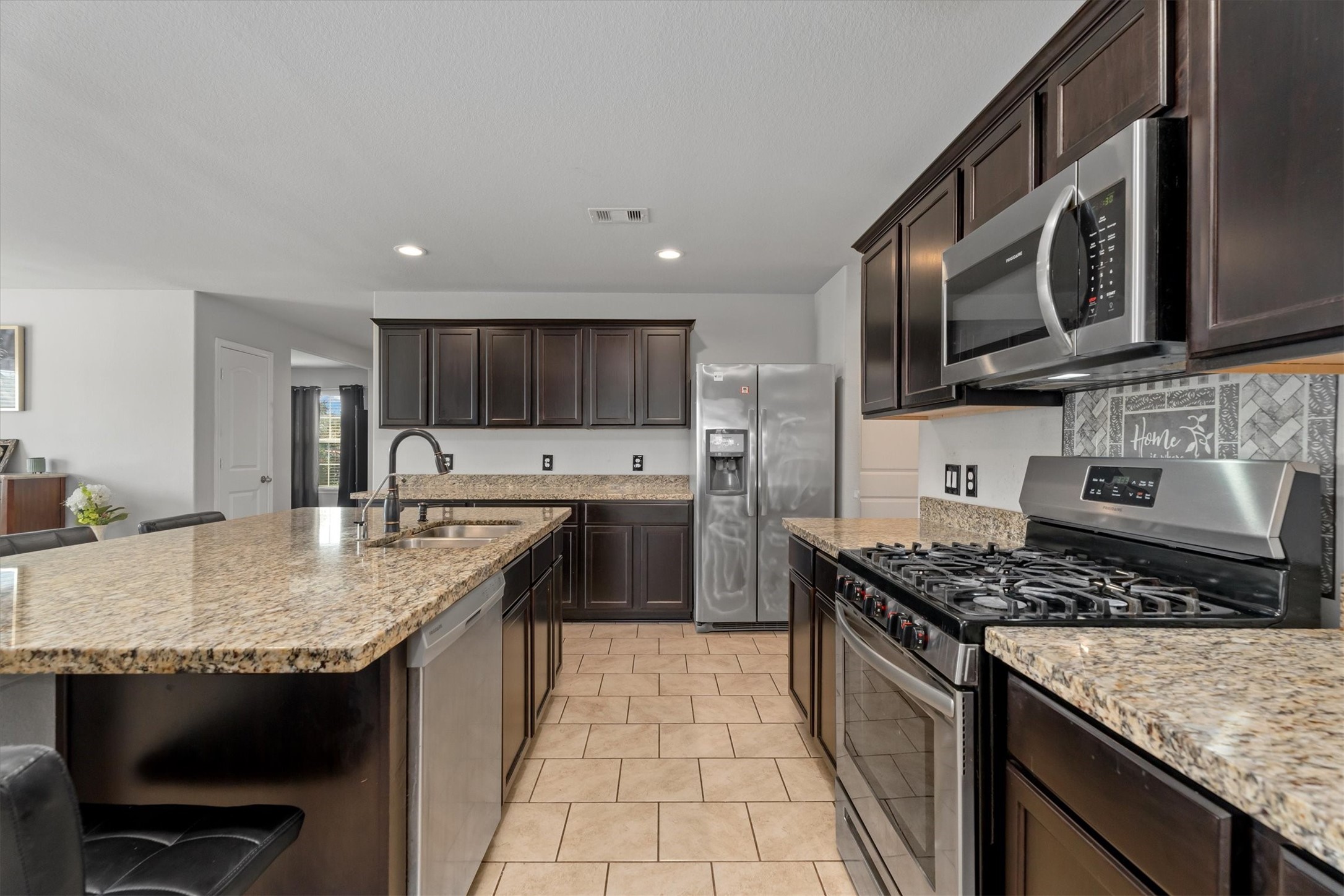 2602 Lincolns Meadow Drive Spring, TX 77373 - Photo 11 of 39 a kitchen with stainless steel appliances granite countertop a sink stove and refrigerator