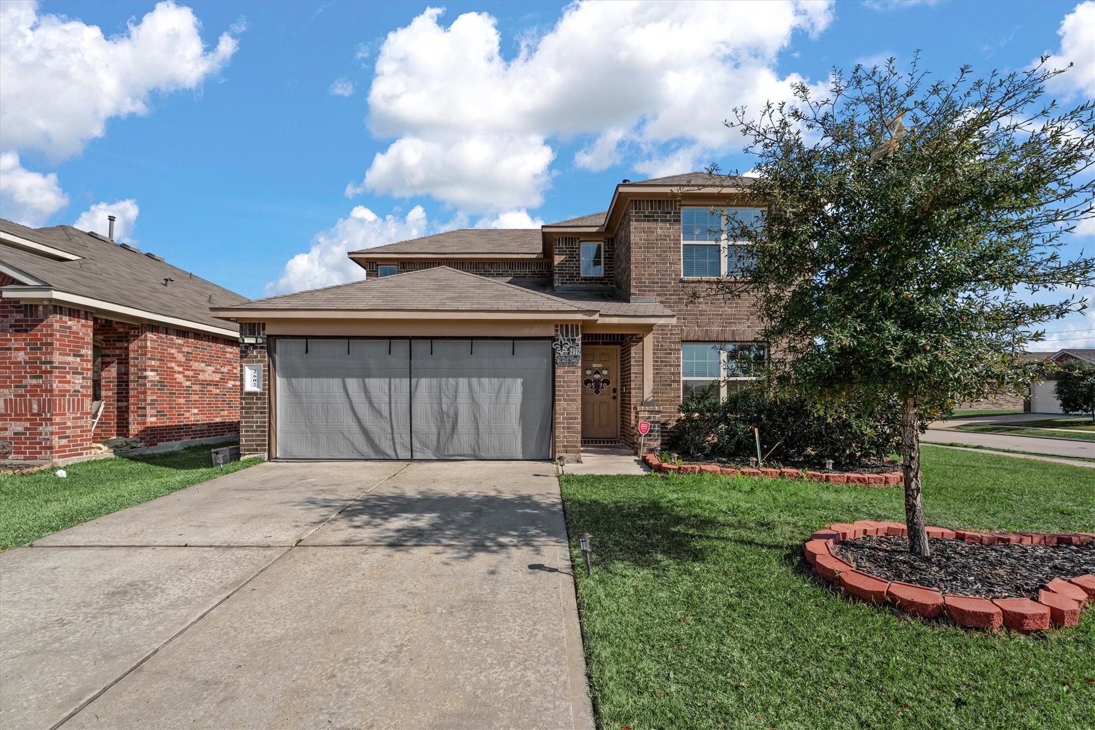 2602 Lincolns Meadow Drive Spring, TX 77373 - Photo 2 of 39 a front view of a house with a yard and garage