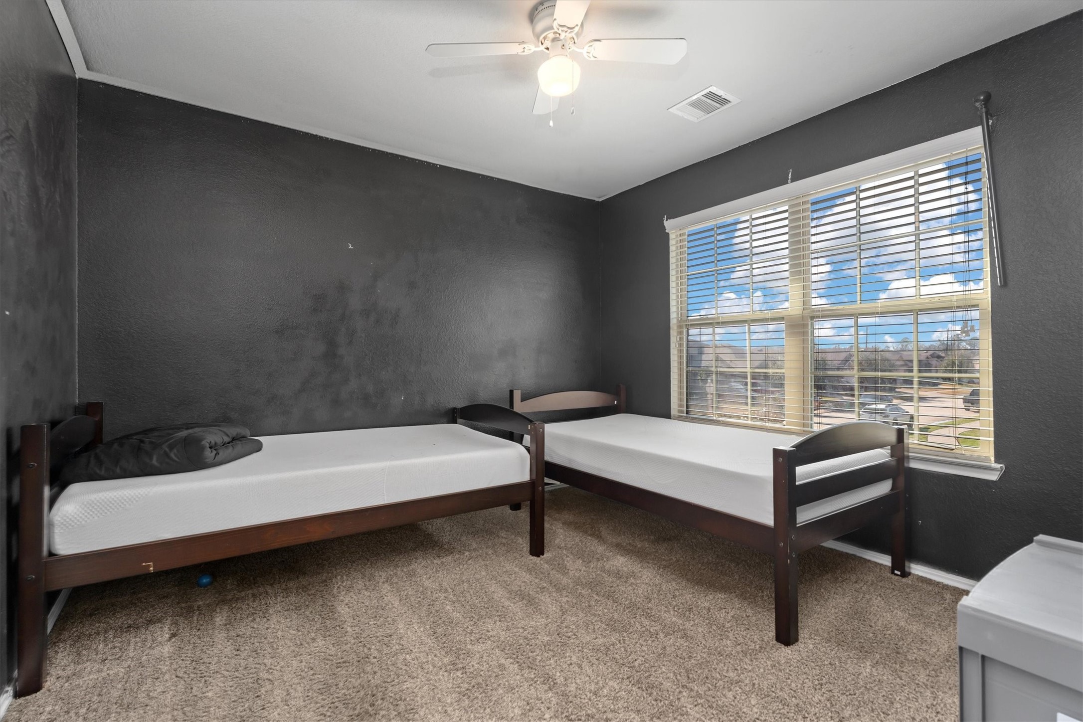 2602 Lincolns Meadow Drive Spring, TX 77373 - Photo 24 of 39 a bedroom with a bed and a chandelier