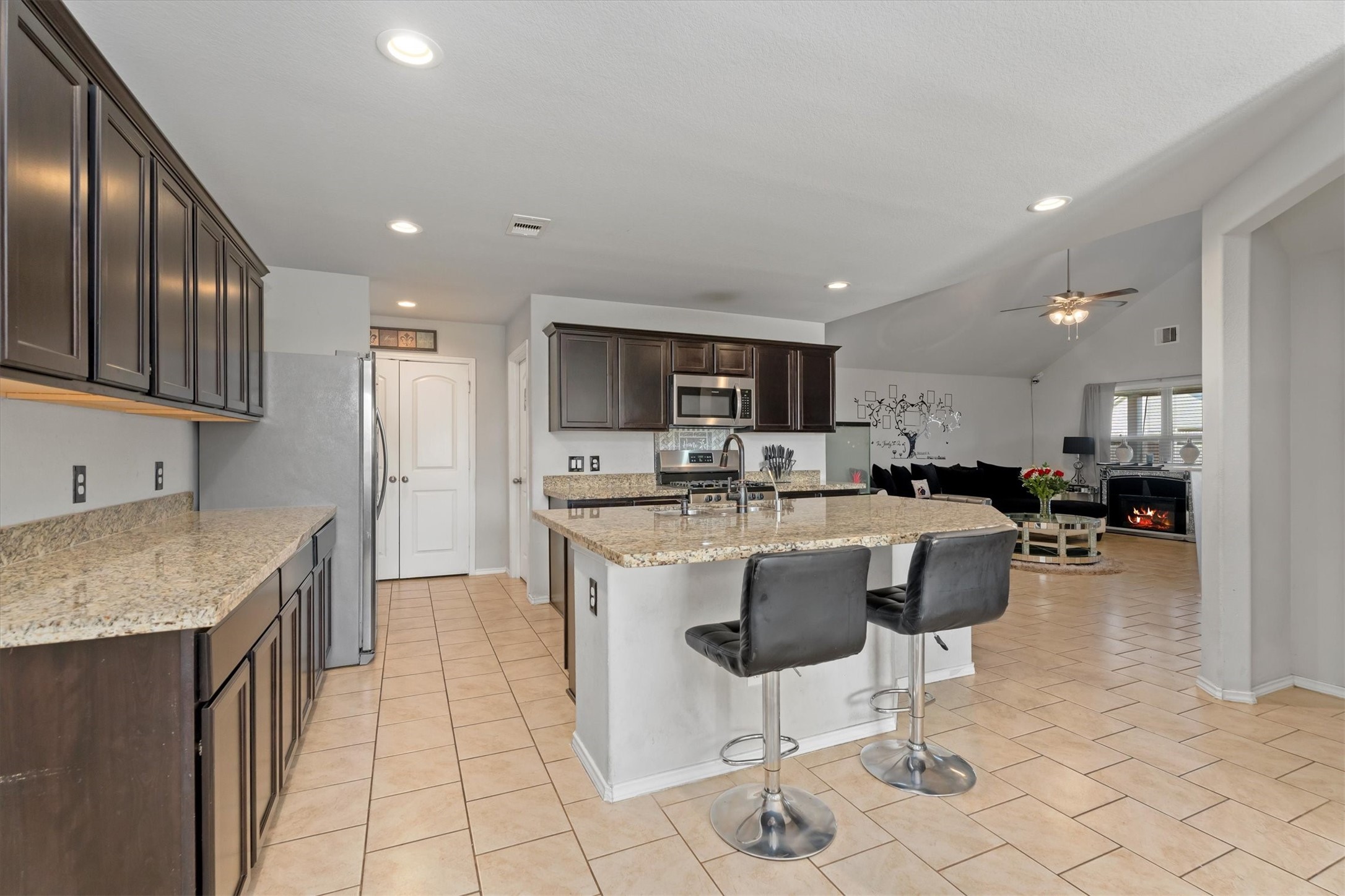 2602 Lincolns Meadow Drive Spring, TX 77373 - Photo 9 of 39 a kitchen with stainless steel appliances kitchen island granite countertop a sink and a refrigerator