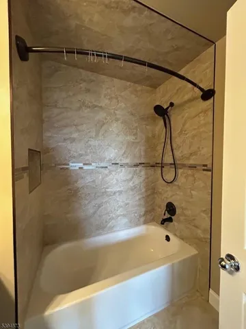 a bath tub sitting next to a shower