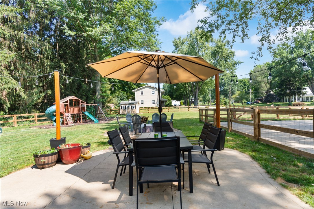 4401 Conestoga Trail Akron, OH 44321 - Photo 24 of 35 Fenced backyard with a playground, a patio, and outdoor dining area