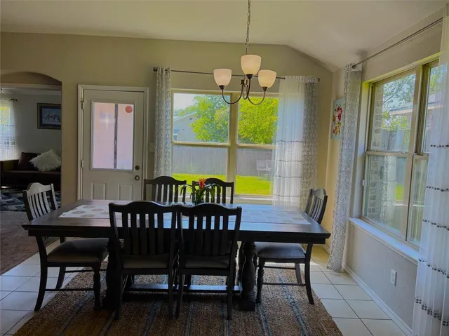 a bedroom with furniture and a large window