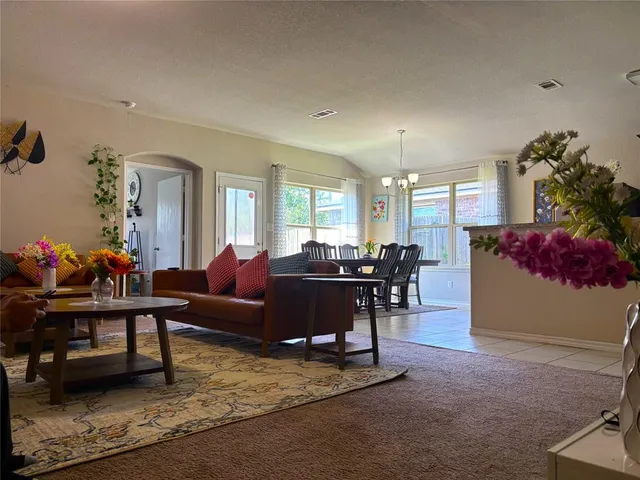a living room with furniture and a potted plant