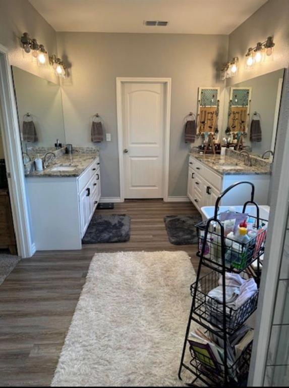306 Embraer Road Abilene, TX 79602 - Photo 12 of 19 a room with kitchen island granite countertop a sink cabinets and wooden floor