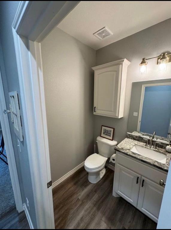 306 Embraer Road Abilene, TX 79602 - Photo 17 of 19 a bathroom with a sink toilet a mirror and vanity