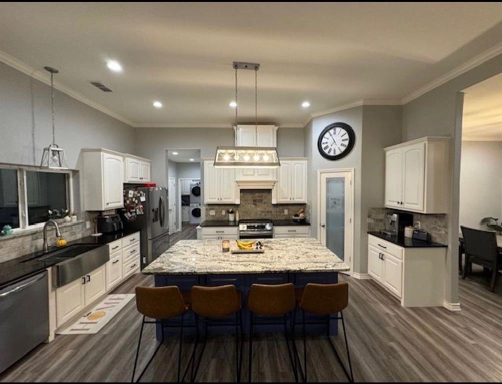 306 Embraer Road Abilene, TX 79602 - Photo 3 of 19 a large kitchen with a table chairs and flat screen tv