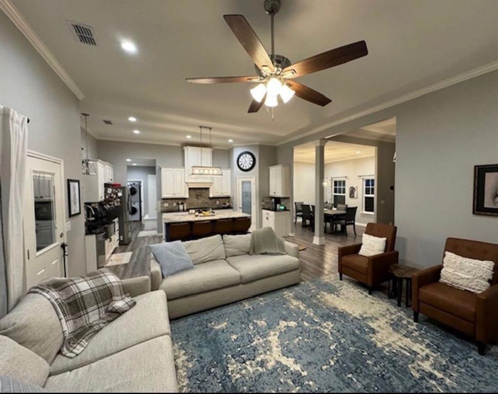 306 Embraer Road Abilene, TX 79602 - Photo 6 of 19 a living room with furniture kitchen view and a chandelier