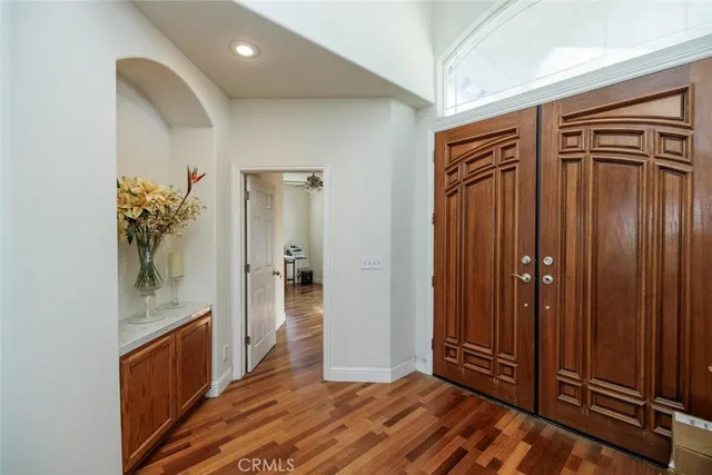 a view of a hallway with wooden shelves