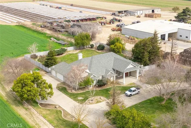 an aerial view of residential houses with outdoor space and parking