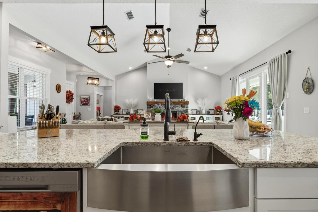 75774 Edwards Road Yulee, FL 32097 - Photo 22 of 70 a kitchen with sink cabinets and chandelier