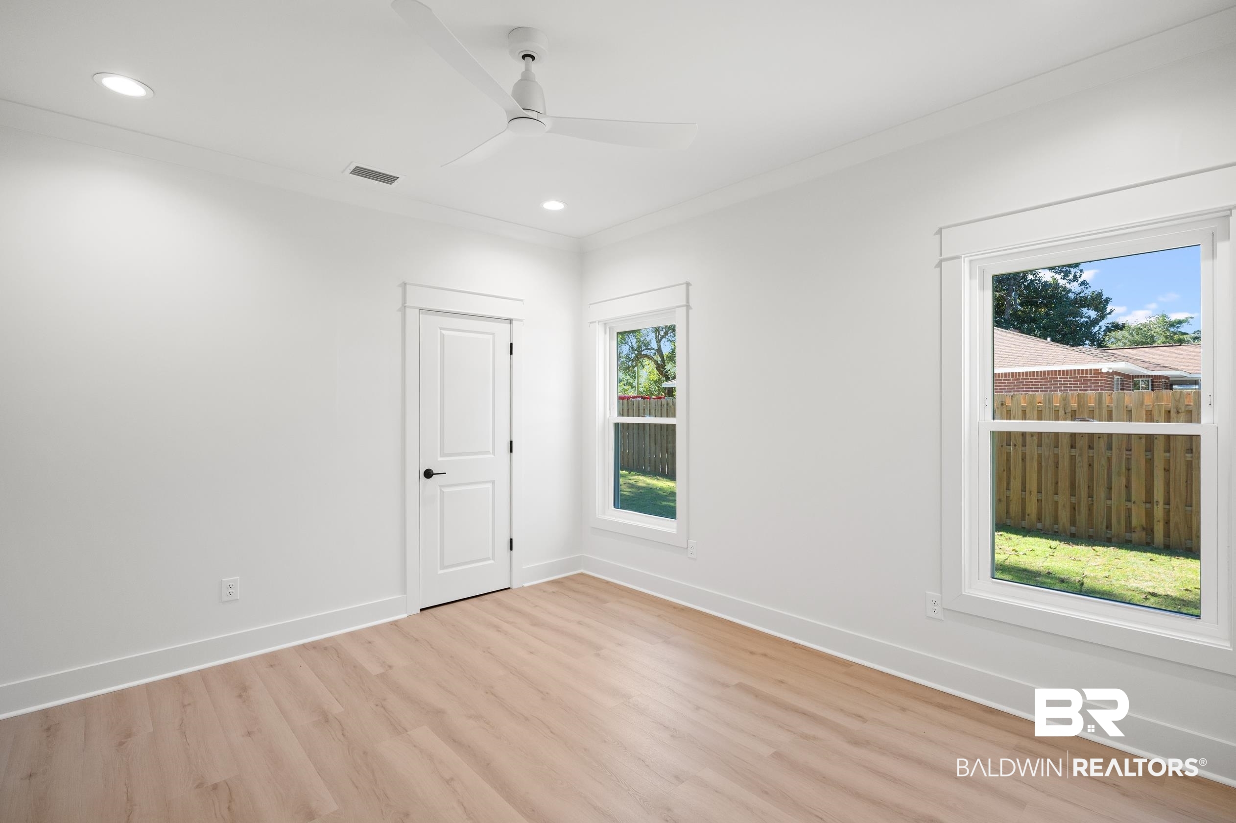 28889 Canal Road Orange Beach, AL 36561 - Photo 25 of 55 Empty room featuring plenty of natural light, ceiling fan, ornamental molding, and light hardwood / wood-style flooring