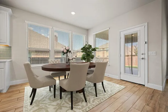 a view of kitchen with wooden floor and electronic appliances