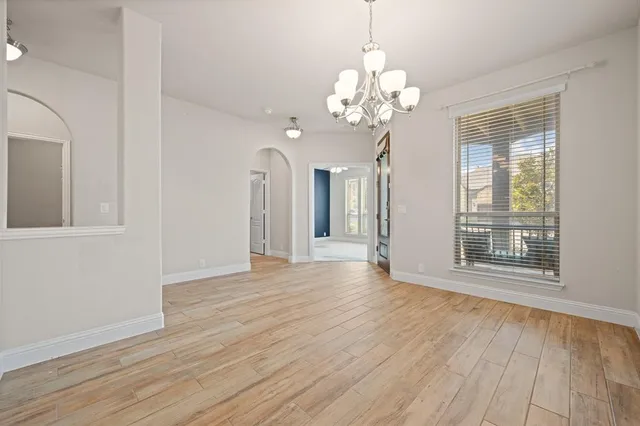 a living room with furniture a table and a large window
