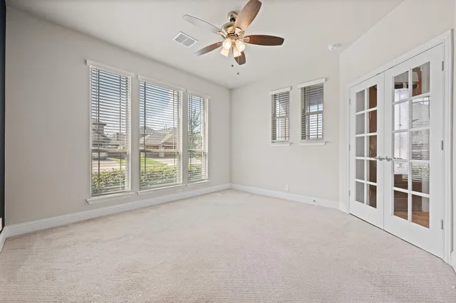 a bedroom with a large bed couch and a window