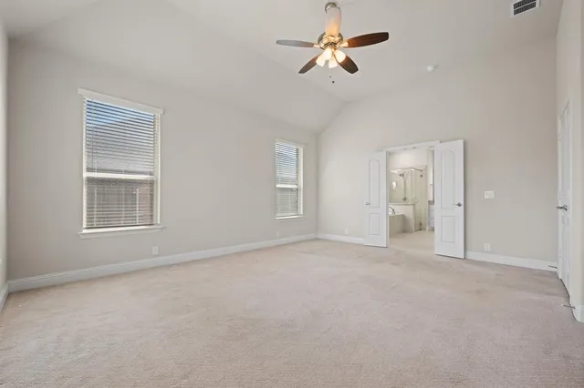 a spacious bathroom with a granite countertop sink mirror and bathtub