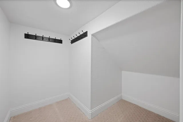 a bathroom with a granite countertop toilet sink and mirror