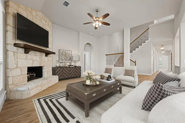 a living room with furniture fireplace and flat screen tv
