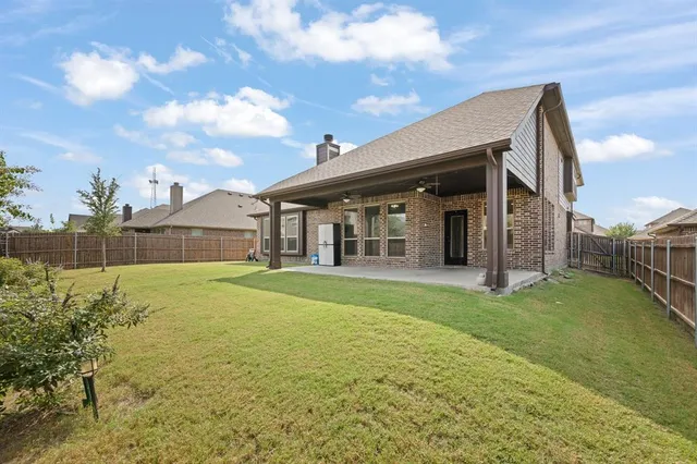 a view of a house with backyard porch and sitting area