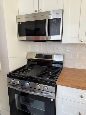 a stove top oven sitting inside of a kitchen