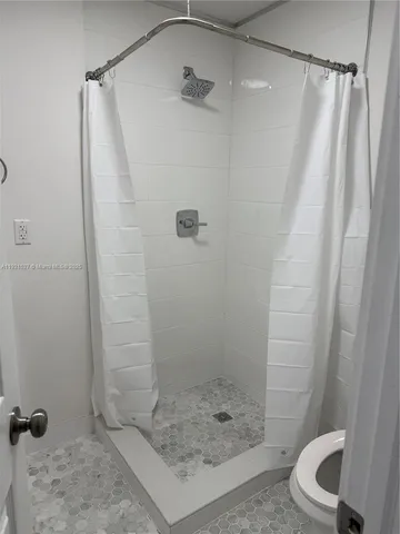 a bathroom with a shower and toilet