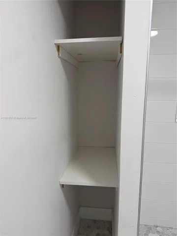 a white toilet sitting next to a shower