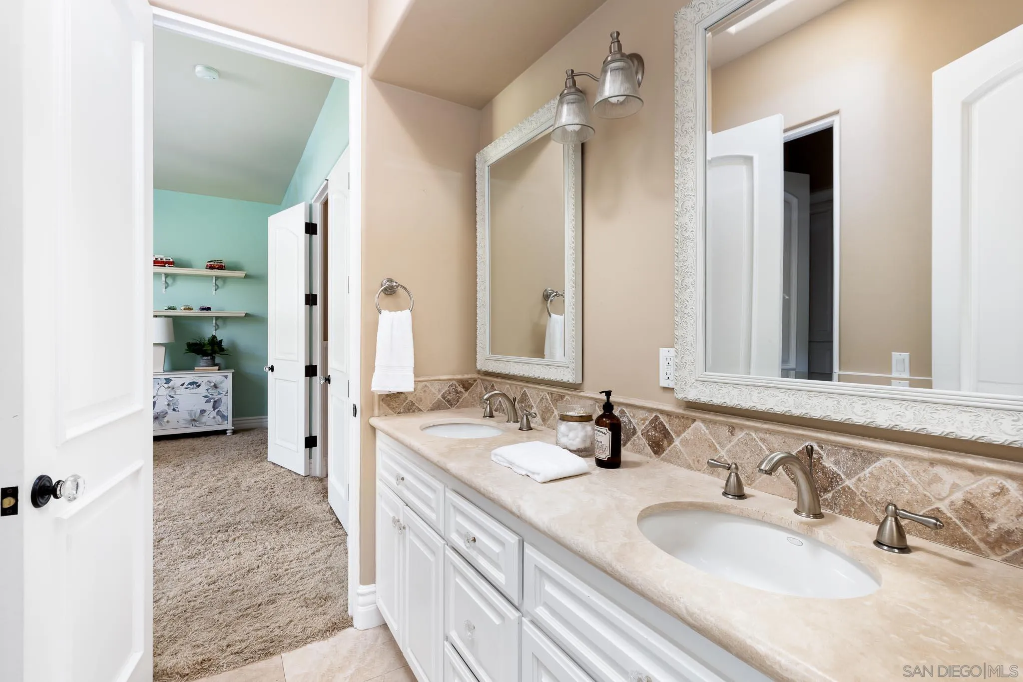 15435 Eastvale Road Poway, CA 92064 - Photo 19 of 57 a en suite bathroom with double sink and a mirror