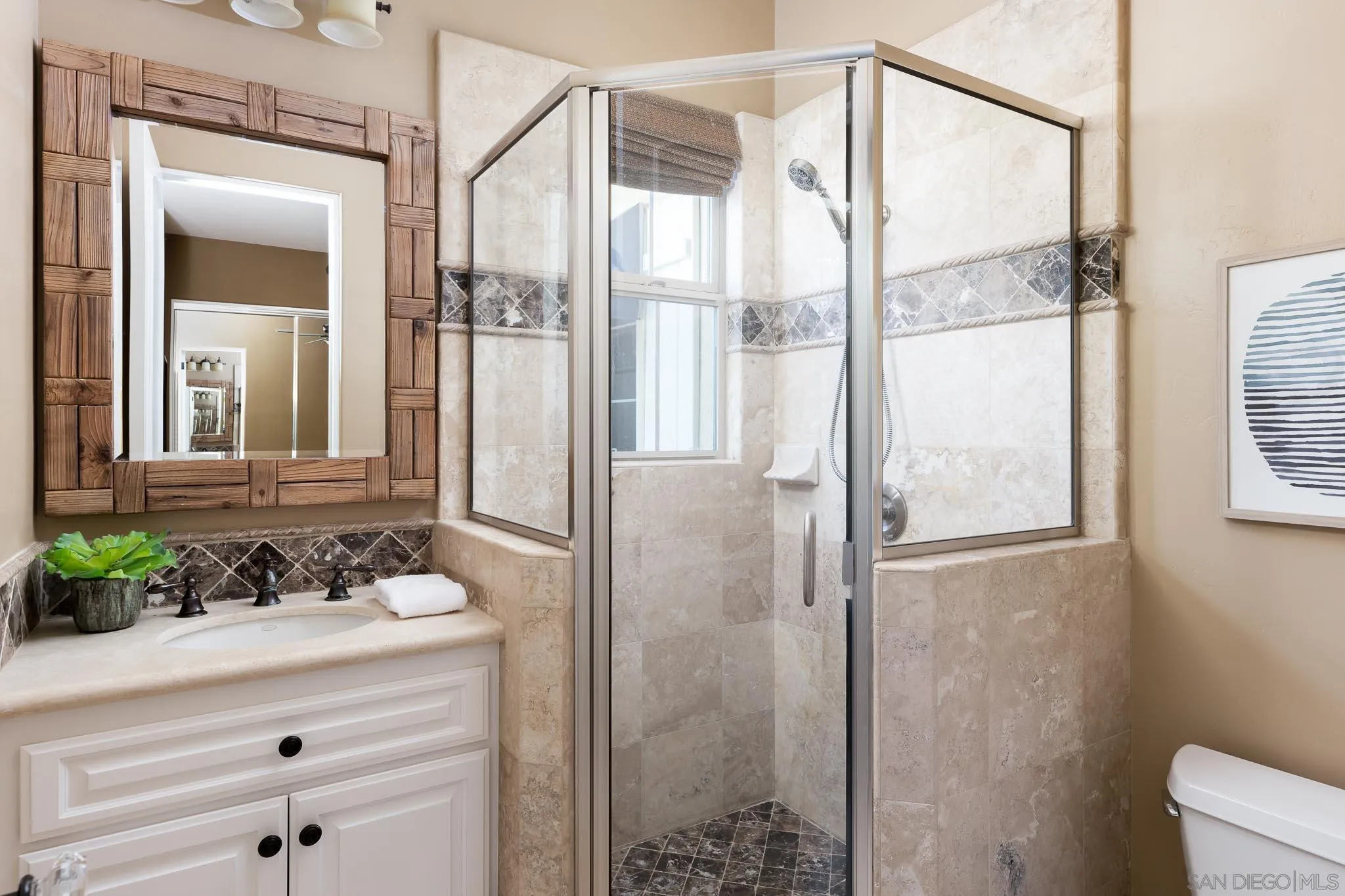 15435 Eastvale Road Poway, CA 92064 - Photo 25 of 57 a bathroom with a shower sink and mirror