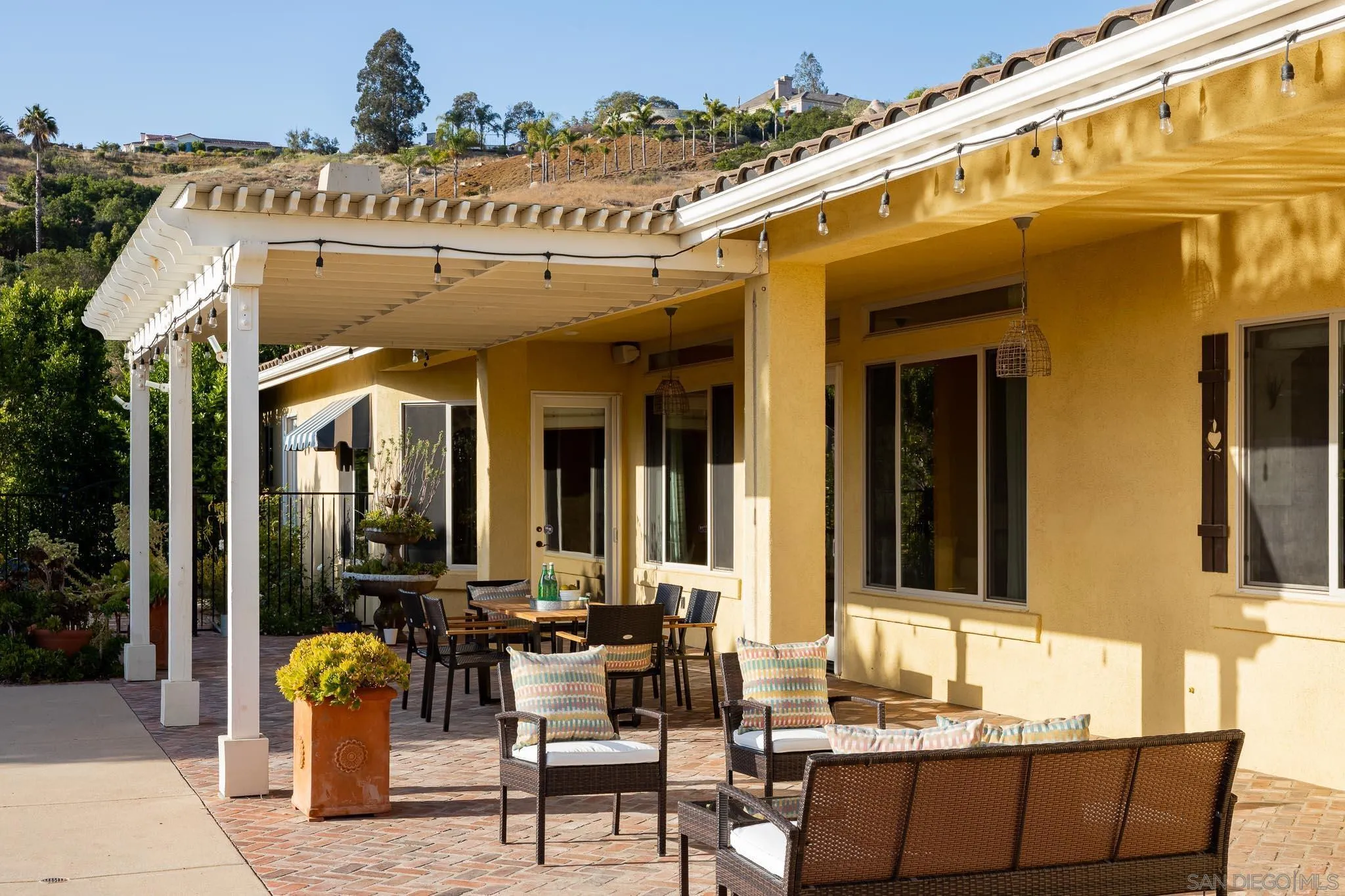 15435 Eastvale Road Poway, CA 92064 - Photo 36 of 57 a view of a patio with dining table and chairs