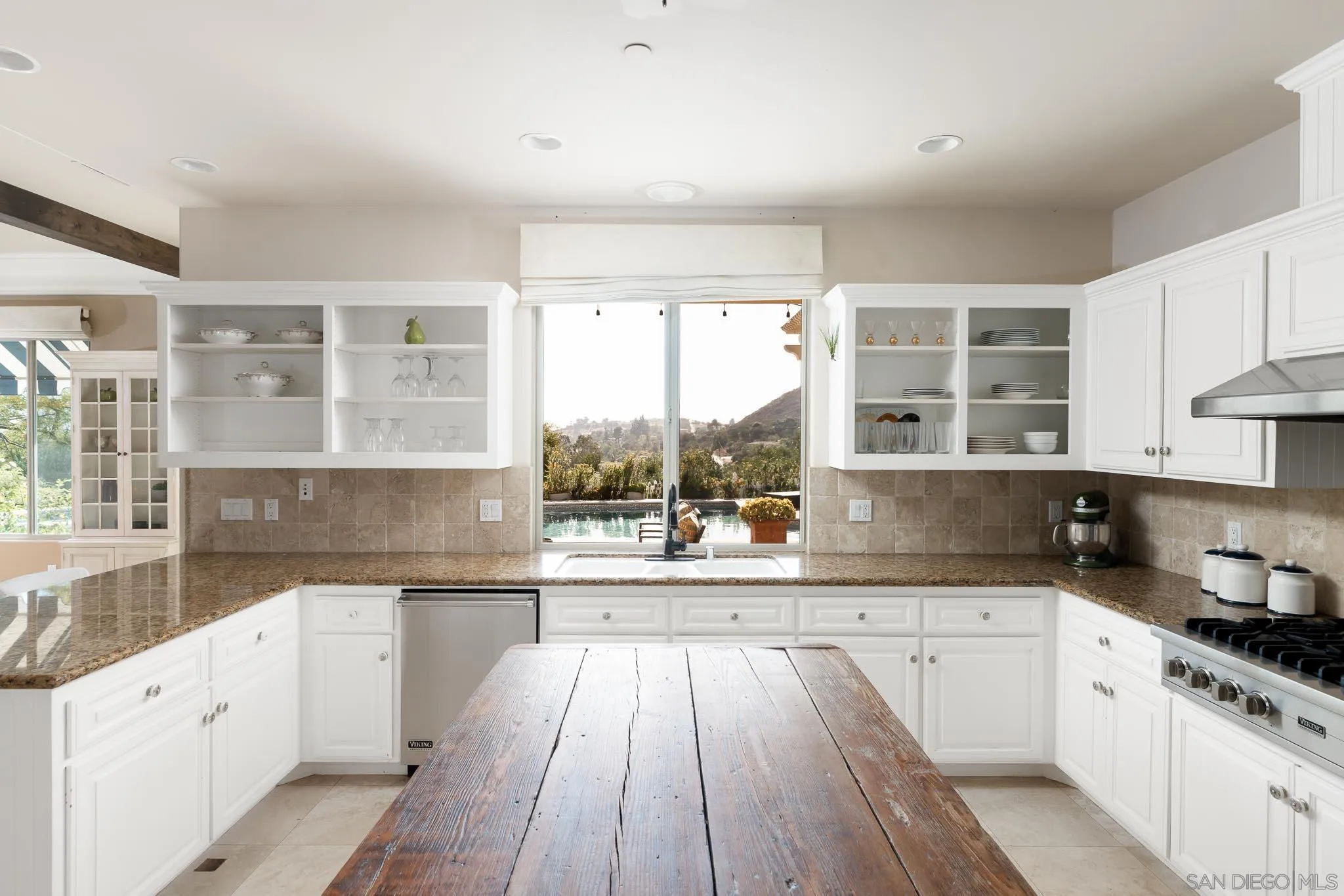15435 Eastvale Road Poway, CA 92064 - Photo 7 of 57 a large kitchen with a lot of cabinets and wooden floor