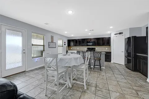 a view of kitchen with refrigerator microwave and cabinets