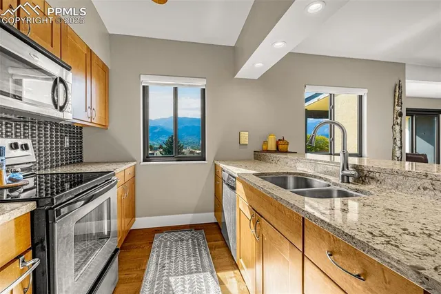 a kitchen that has a sink and a stove