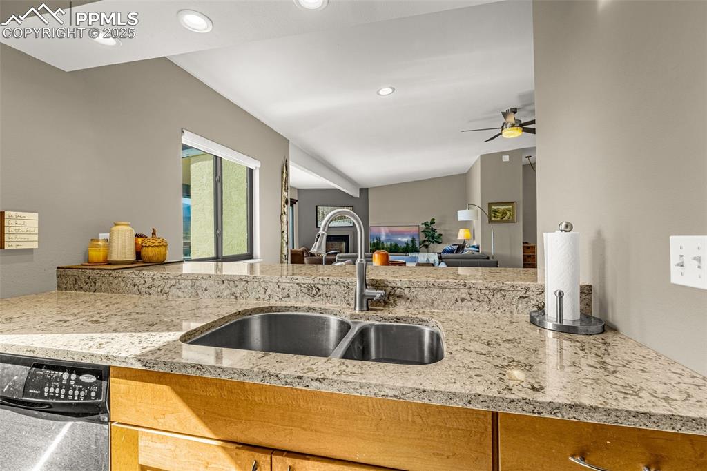 1130 Fontmore Road, Unit D Colorado Springs, CO 80904 - Photo 16 of 33 a kitchen with stainless steel appliances granite countertop a sink a counter top space and cabinets