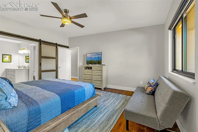 a bedroom with a bed and a dresser next to a window