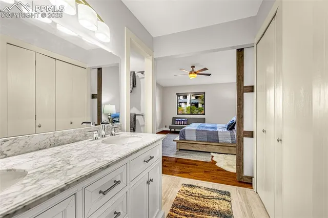 a spacious bathroom with a granite countertop sink and a mirror