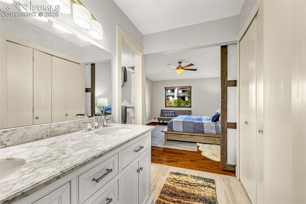 1130 Fontmore Road, Unit D Colorado Springs, CO 80904 - Photo 19 of 33 a spacious bathroom with a granite countertop sink and a mirror