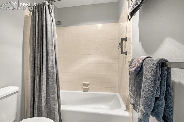 a bathroom with a tub and a shower