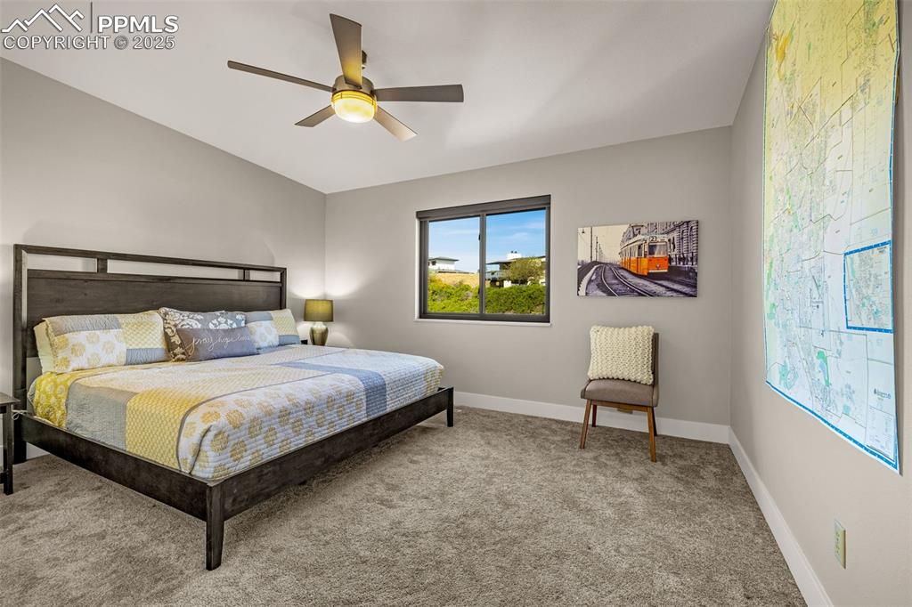 1130 Fontmore Road, Unit D Colorado Springs, CO 80904 - Photo 22 of 33 a bedroom with a bed and a chandelier
