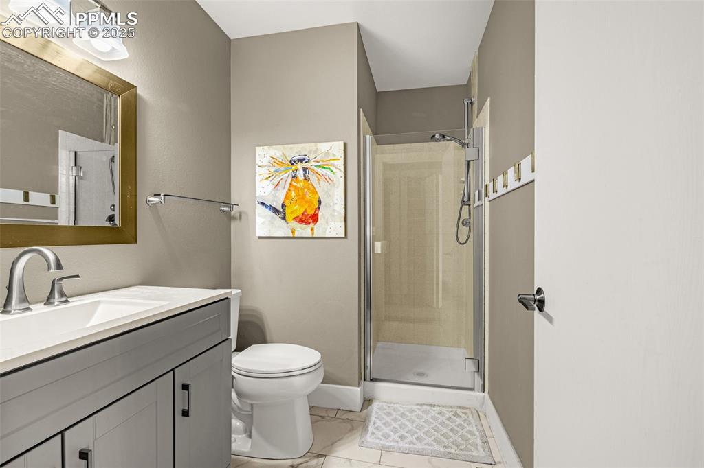 1130 Fontmore Road, Unit D Colorado Springs, CO 80904 - Photo 25 of 33 a bathroom with a toilet a sink and shower