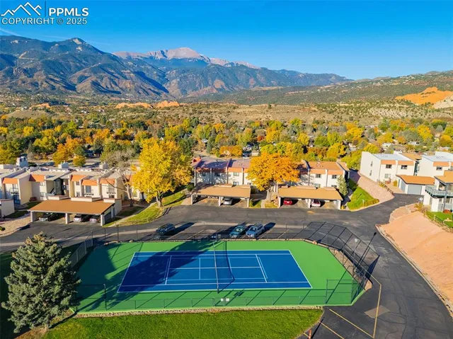 an aerial view of residential houses with outdoor space and swimming pool