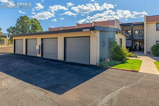a view of a house with a patio and a yard