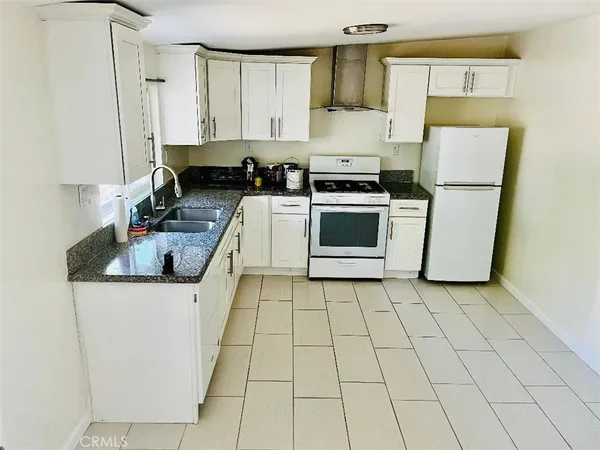 a kitchen with a sink a stove and cabinets