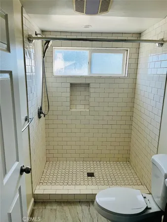a bathroom with a toilet and shower