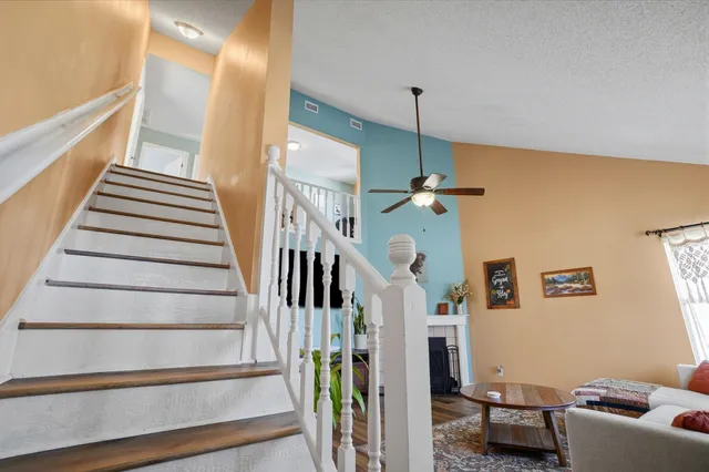a view of a livingroom with wooden floor and a workspace
