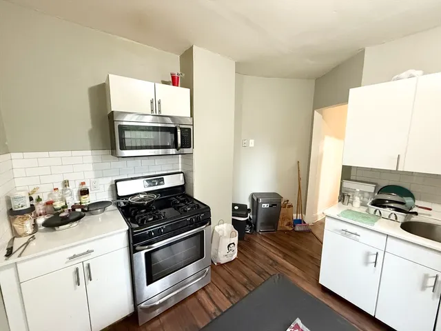 a kitchen with a sink appliances and cabinets